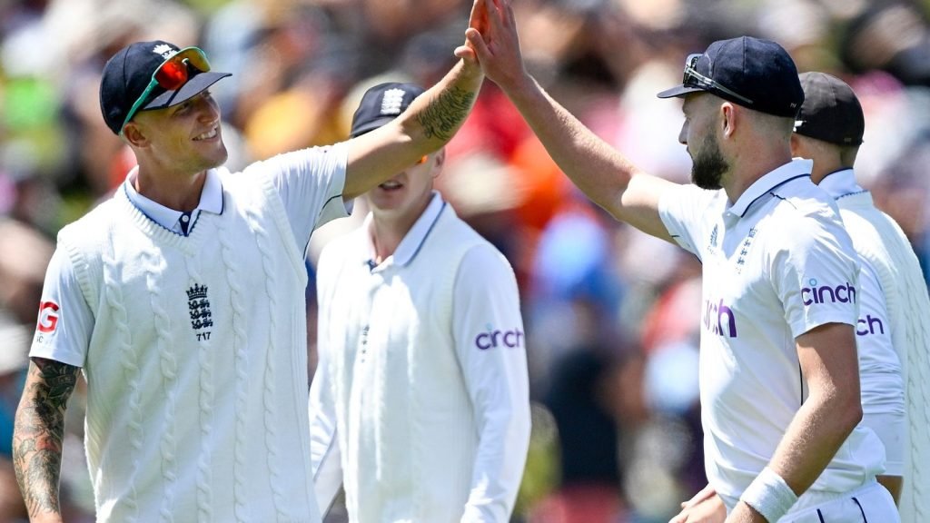 England bowler Gus Atkinson is congratulated by teammate Brydon Carse, left, after taking a hat trick during play on day two of the second cricket test between New Zealand and England at the Basin Reserve in Wellington, New Zealand, Saturday, Dec.7, 2024. (Andrew Cornaga/Photosport via AP)