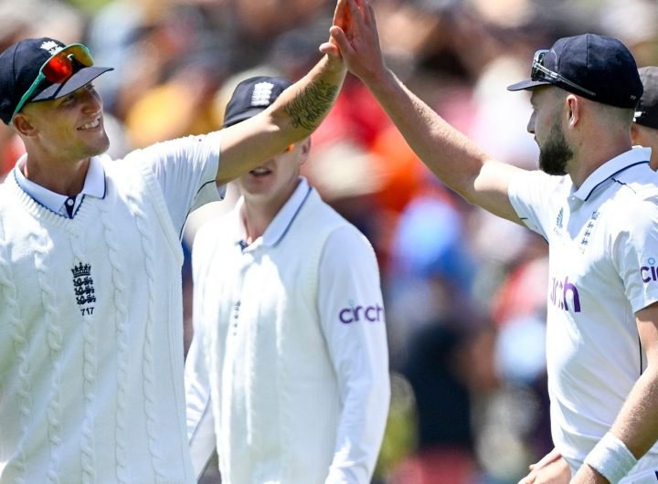 England bowler Gus Atkinson is congratulated by teammate Brydon Carse, left, after taking a hat trick during play on day two of the second cricket test between New Zealand and England at the Basin Reserve in Wellington, New Zealand, Saturday, Dec.7, 2024. (Andrew Cornaga/Photosport via AP)