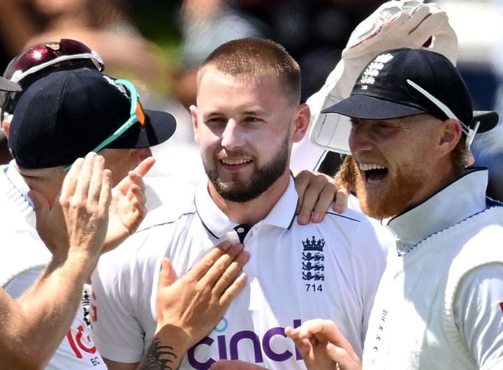 Gus Atkinson is mobbed by his England team-mates after taking a hat-trick on day two of the second Test against New Zealand