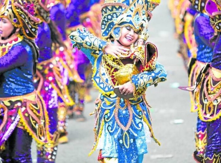 Sinulog 2025: Partial list of contingents. In photo is a woman dancing holding the image of the Sto. Niño de Cebu in a previous Sinulog performance.