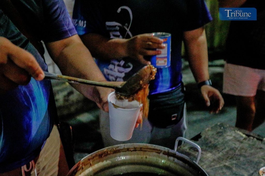 Youth volunteers prepared and offered hot champorado to attendees of the first morning of misa de gallo at The Cubao Cathedral, Quezon City on Monday,