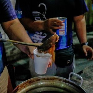 Youth volunteers prepared and offered hot champorado to attendees of the first morning of misa de gallo at The Cubao Cathedral, Quezon City on Monday,