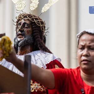 Catholic devotees hand over handkerchiefs to be wiped on a replica of Jesus Nazareno outside the Minor Basilica and National Shrine of Jesus Nazareno