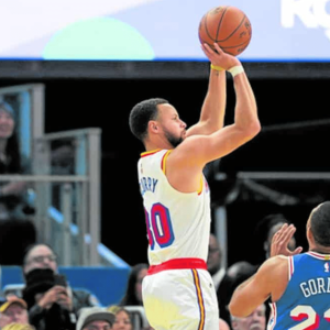 Steph Curry (left) drains one of his eight triples in leading the Warriors to a rout of the Sixers.