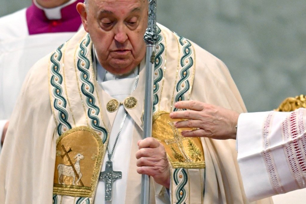 LOOK: Pope Francis looks down at his staff as he celebrates New Year's Day during a mass on World Day of Peace in Saint-Peter's Basilica at the Vatica