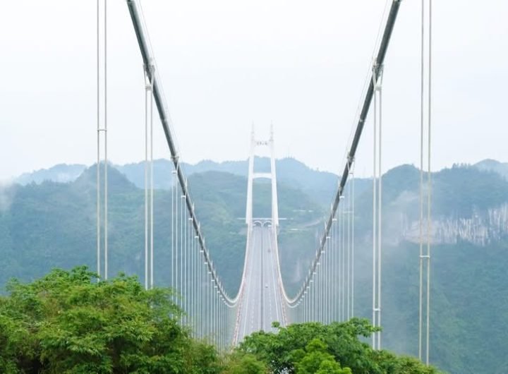 Suspended 355 meters above the Dehang Canyon, the bridge offers stunning views of rolling mountains, pockets of greenery, and tiny rural villages scat