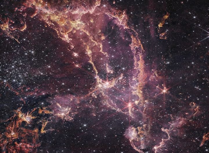 a band of glowing pink-and-gold gasses surrounded by bright stars