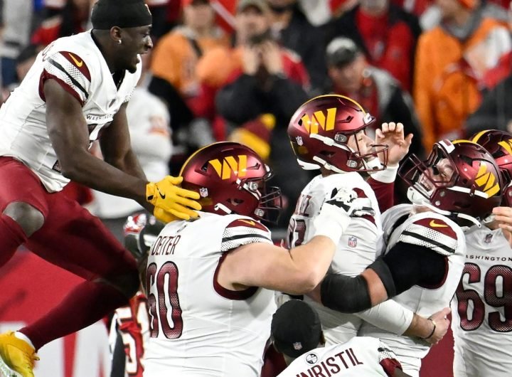 Washington Commanders place kicker Zane Gonzalez, middle, is congratulated by teammates after kicking the game winning field goal against the Tampa Bay Buccaneers during the second half of an NFL wild-card playoff football game in Tampa, Fla., Sunday, Jan. 12, 2025. (AP Photo/Jason Behnken)