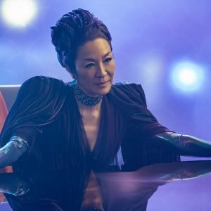 Philippa Georgiou (Michelle Yeoh) sitting behind a desk in her nightclub in the Star Trek: Section 31 movie.