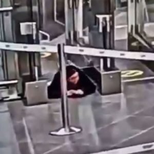 Watch moment woman crawls under airport security barrier before sneaking onto PLANE completely unnoticed